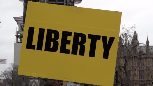 Yellow Placard Word Liberty Thick Black Writing Held Front Houses — Stock Video