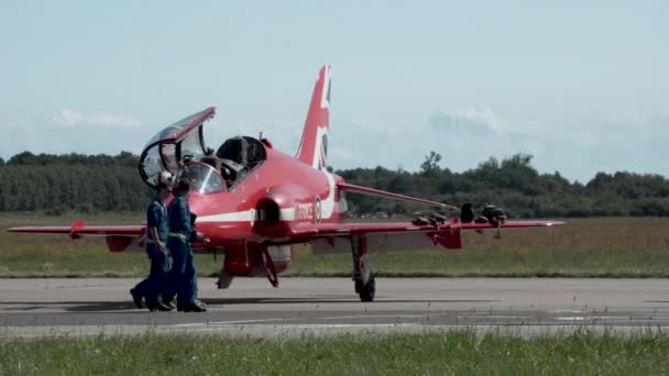 研磨空港で晴れた日に滑走路を歩く赤い矢印のパイロットの追跡ショット グディニアのエアロバルティックショー2021 — ストック動画
