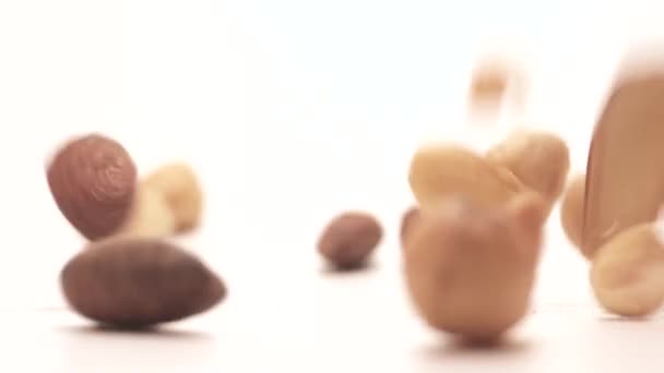 Slow Motion Assorted Dry Nuts Dropping Surface Close — Stock Video