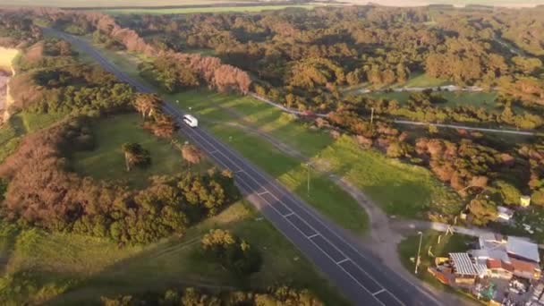 Aerial Tracking Shot Tourism Bus Driving Asphalt Road Surrounded Ocean — Wideo stockowe