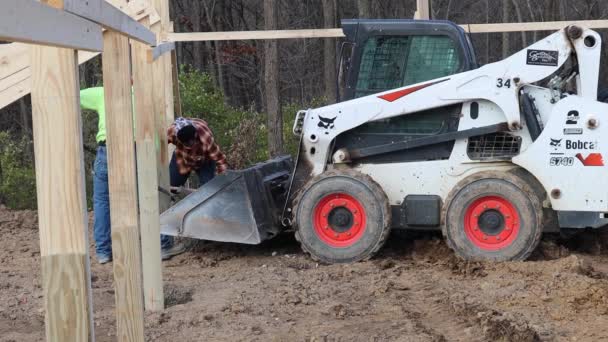 Crew Shoveling Wet Cement Loader Bucket Post Hole Principal Poles — Stock Video