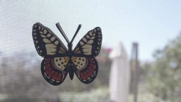 Schöner Künstlicher Schmetterling Auf Gitterfenster — Stockvideo