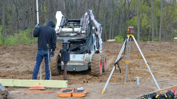 Construction Worker Watching Hydraulic Specialized Tool Mounted Skid Steer Loader — Stock Video