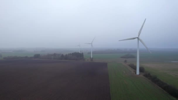 Drone Flying Foggy Field Rotating Wind Turbines — ストック動画