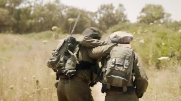 Two Lonely Injured Soldiers Supports Each Other Limping Dry Vegetation — Stock Video