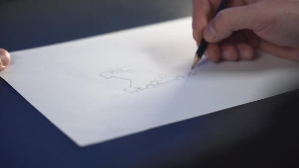 Hand Holding Black Pencil Drawing Concept Picture Blue Desk — Stock Video