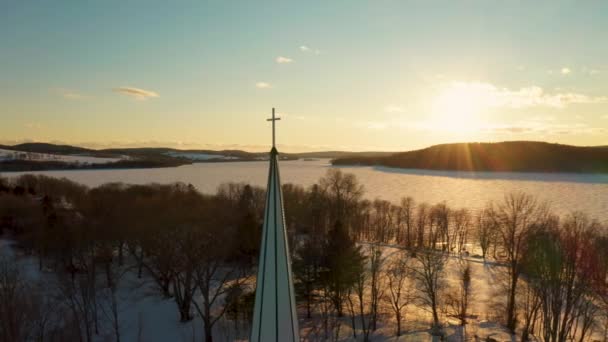 Scenisk Antenn Utsikt Över Ett Kyrktorn Mot Vintersolnedgång Över Frusen — Stockvideo