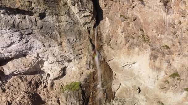High Mountain Waterfall Rocky Wall Rainbow Colors Aerial Pullback Shot — Stock Video