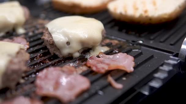 グリルでチーズとベーコンの調理とジューシーな肉はハンバーガーを準備します スローモ — ストック動画