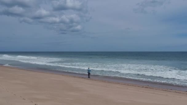 Lonely Single Fisherman Standing Cape Cod Beach Fixing His Fishing — Stock Video