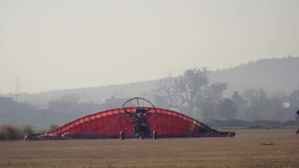 Pilot Walks Away Paraglider Landing Runway — Stock Video