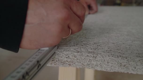 Handyman Marking Acoustic Panel Using Pencil Folding Ruler — Stock Video