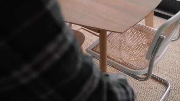 Junger Mann Mit Staubsauger Zwischen Stühlen Unter Einem Tisch Wohnzimmer — Stockvideo