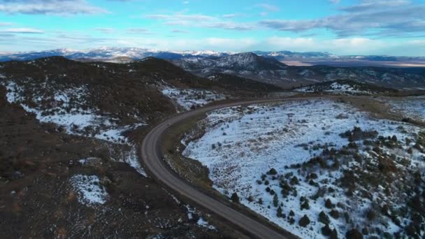 Drone Aerial View Large Bending Highway Amongst Mountains Snow — Stock Video