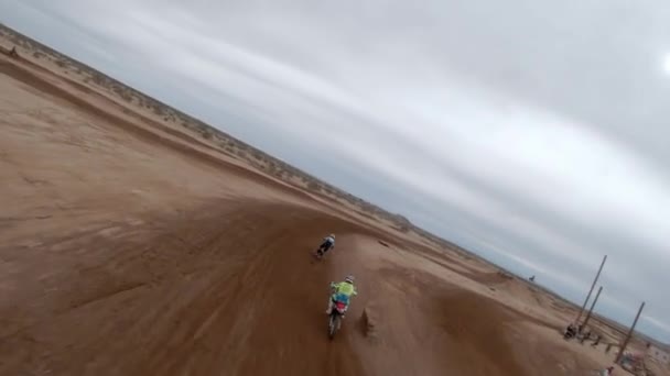High Speed Drone Motorcycles Race Track Taking Jumps Mojave Desert — Stock Video