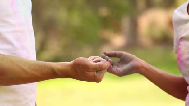 Close Hands Young Couple Playing Powder Paint Female Slaps Male — Stock Video