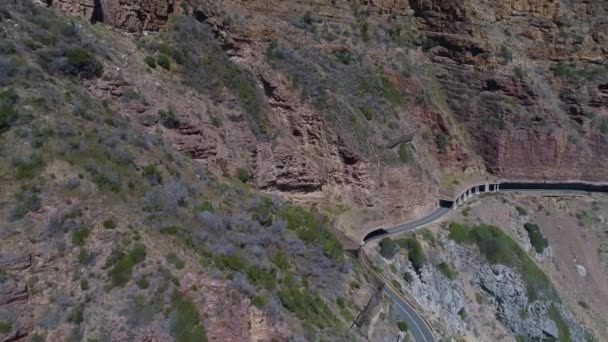 Drone Panning Shot Car Driving Scenic Coastal Road Cut Cliff — Wideo stockowe