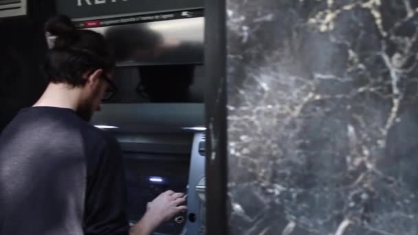 Young Man Withdrawing Money Bank Counter Paris France Pan Right — Stock Video