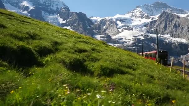 Static Shot Red Train Carrying Tourists Downhill Jungfrau Mountain Range — Stock Video