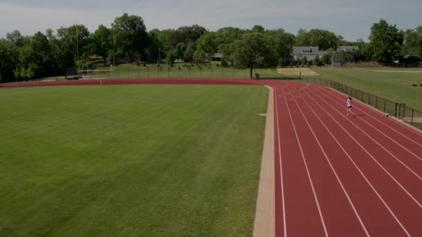 Teenage Girl Athlete Runs Track Bend Football Goal Post Scene — Stock Video