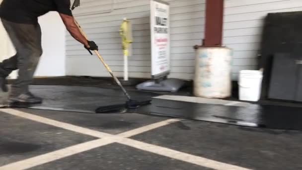 Man Applying Seal Coating Parking Lot Pavement — Stock Video