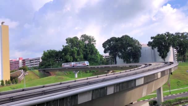 Light Rail Transit Trein Passeert Een Verhoogde Gebogen Spoorweg Overdag — Stockvideo