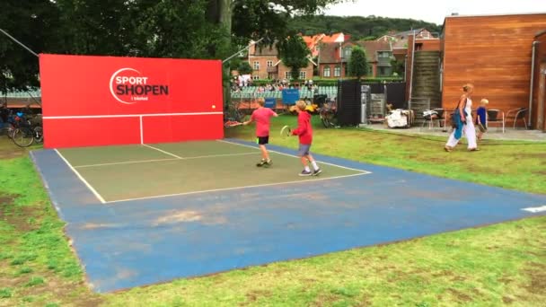 夏には屋外でテニスをする子供たち 楽しいリラックスレクリエーション活動 — ストック動画