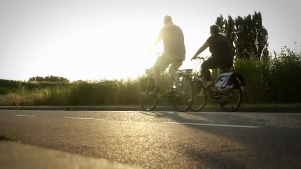 Two Leisure Cyclists Passing Bikes Sunset Sunrise Slow Motion Low — Stock Video