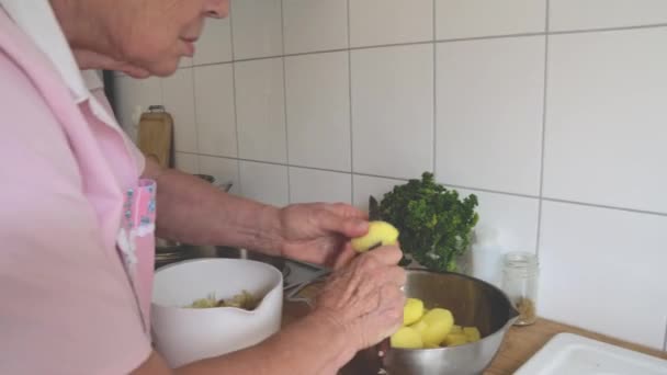 Κυρία Στο Σπίτι Κόβει Και Ξεφλουδίζει Πατάτες — Αρχείο Βίντεο