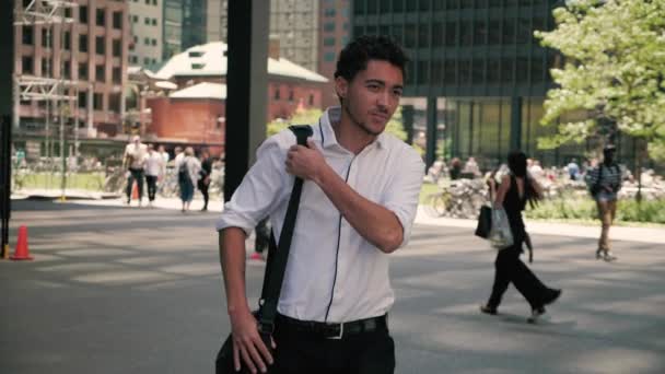 Confident Mixed Race Businessman Walks Busy Courtyard Laptop Bag Shoulder — Stock Video