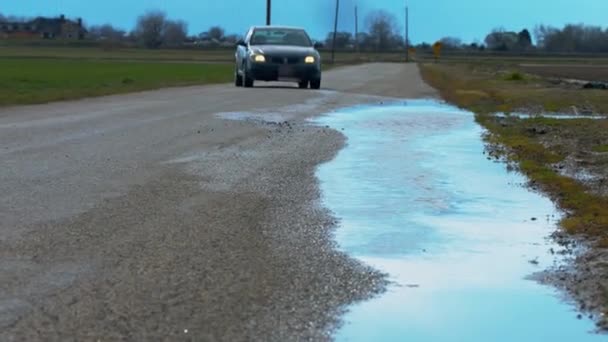 Sebuah Mobil Sengaja Berjalan Melalui Genangan Air Sisi Lain Jalan — Stok Video
