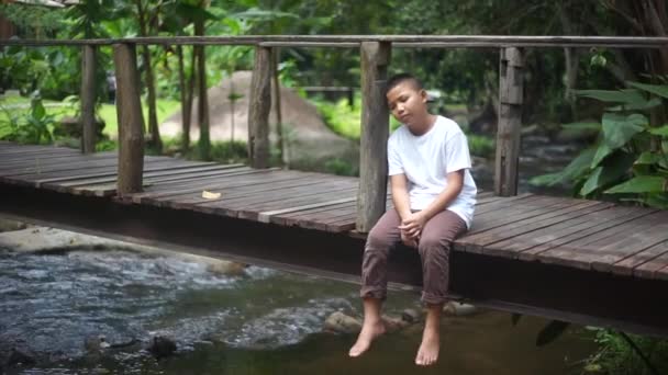 Sad Young Asian Boy Sitting Alone — Stock Video