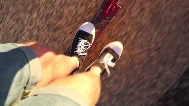 Menino Está Montando Sua Scooter Por Caminho Banhado Pela Luz — Vídeo de Stock