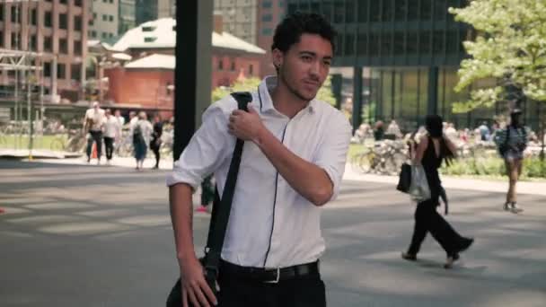 Confident Mixed Race Businessman Walks Busy Courtyard Laptop Bag Shoulder — Stock Video