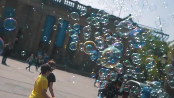 Beautiful soap bubbles blown by a street performer on the streets of Edinburgh with kids and adults in the background(slow motion) (editorial)