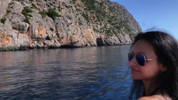 Woman on a boat sailing through the Mediterranean Sea, along the coast of Palma de Mallorca