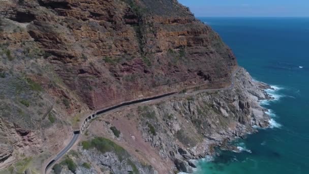 Drone Flies Backwards Revealing Beautiful Coastal Road Cut Cliffs — Stock Video