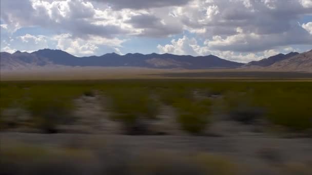 Conduzindo Rápido Pelo Deserto Califórnia Com Montanhas Horizonte Nuvens Céu — Vídeo de Stock
