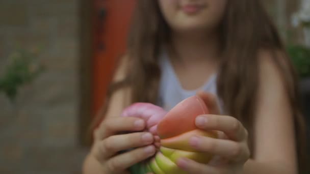 Kleines Mädchen Auf Der Veranda Spielt Mit Einer Muschel Squishy — Stockvideo
