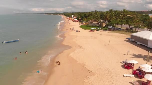 Cinematic Aerial Flyover Beach Porto Seguro Brazil People Swimming Ocean — стоковое видео