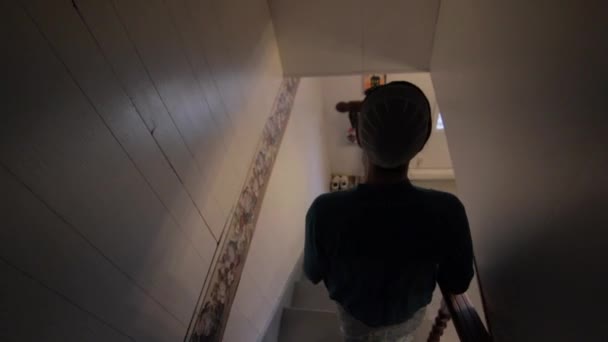 一个年轻的门诺派女人走下楼梯走进厨房 — 图库视频影像