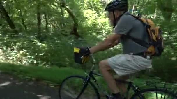 Closeup Angled Shot Elderly Gentleman White Beard Biking Forest Area — Stock Video