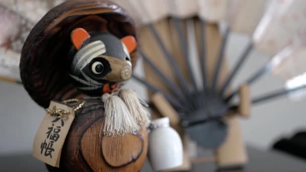 Close Beautiful Handmade Wooden Japanese Asian Tanuki Figurine Fan Background — Stock Video