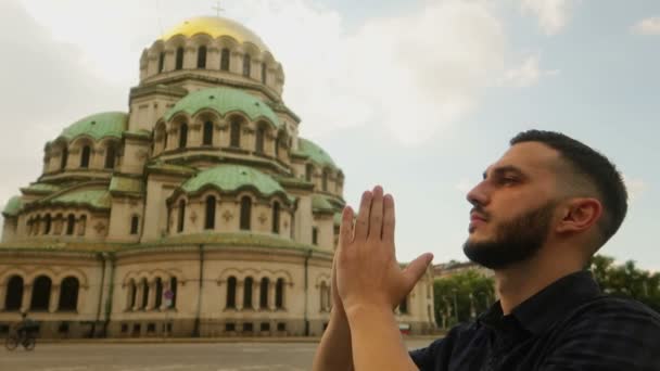 Jovem Muçulmano Reza Pela Paz Diante Templo Cristão Velha Catedral — Vídeo de Stock