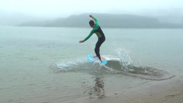 水泳ボードの上を走り霧の海に飛び込みスローモーションで泳ぎ — ストック動画