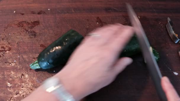 Hand Holding Knife Slicing Zucchini Brown Cutting Board — Stock Video