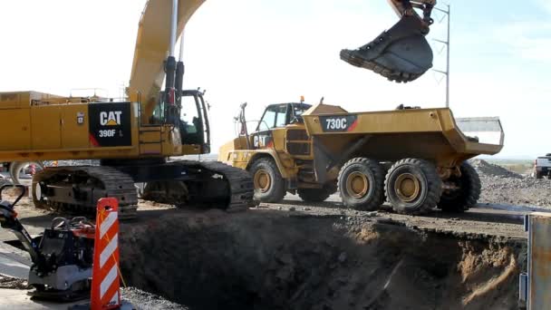 Caterpillar 390F Excavator Loads 730C Articulated Truck Sewer Line Replacement — Stock Video