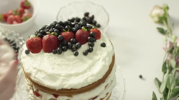 Woman Places Flower Top Cake Berries — Stock Video