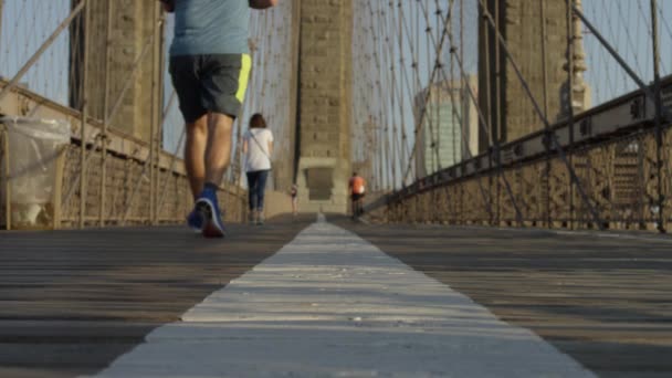 People Jog Brooklyn Bridge Walkway Slow Motion — Stock Video