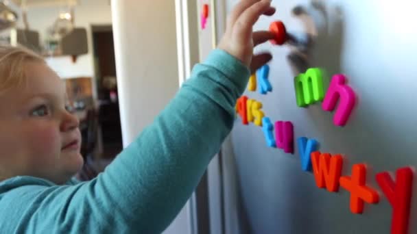 Toddler Playing Colorful Fridge Magnets — Stock Video